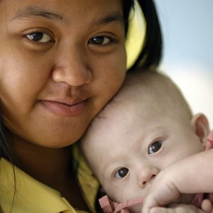 Gammy, a baby born with Down's Syndrome, is held by his surrogate mother in Chonburi province